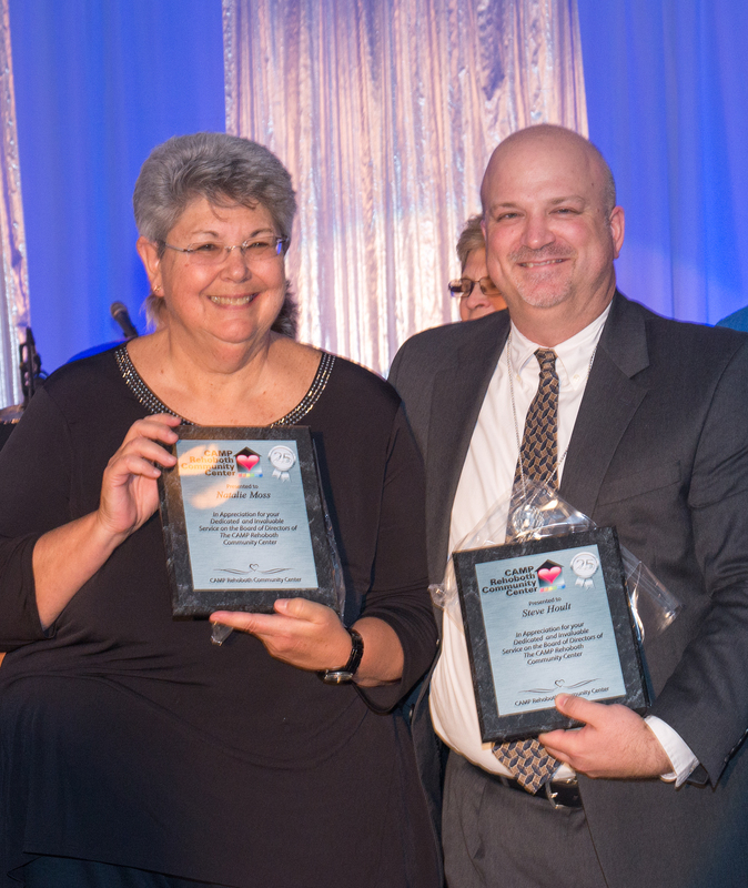 Receiving appreciation for dedicated and invaluable service on the board of directors of The CAMP Rehoboth Community Center are Natalie Moss, left, and Steve Hoult. BY DENY HOWETH